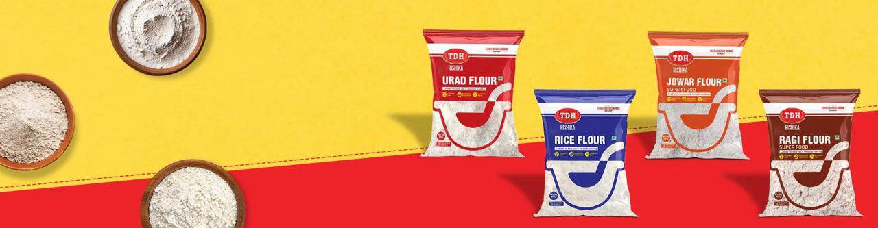 Four bags of flour with different brands on a red and yellow background