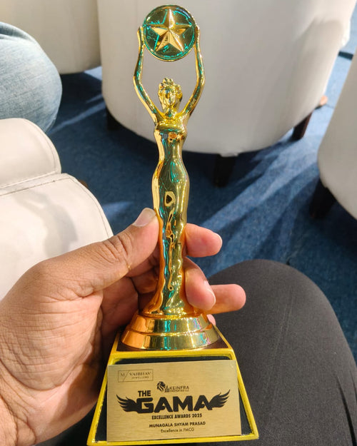 Gold trophy with a star on top held by a person, featuring the GAMA logo.